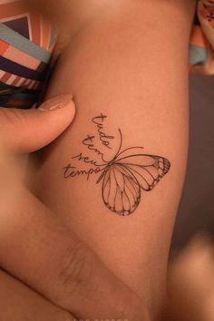 a woman's thigh with a butterfly tattoo on it and the words, you are not