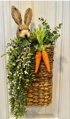 a basket filled with carrots and greenery hanging on a door handle that says, my spring, easter decor hanging