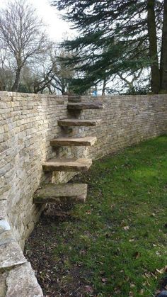 a stone wall with steps leading up to it