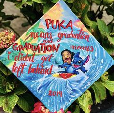 a graduation cap that has been decorated with cartoon characters