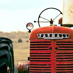 an old red farmall tractor with the word farmall on it's front