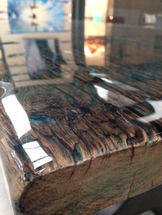 a close up of a marbled table with metal legs and an acrylic top