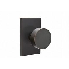 an image of a black square knob on a wall