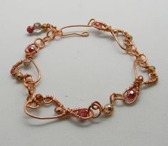 This is a beautiful delicate looking bracelet hand crafted out of pure copper wire.   The design is a unique art nouveau inspired swirl and has a delicate airy feel. The bracelet is solidly crafted out of heavier wire so it will last for years. The cut glass beads woven into the design are in tones of metallic gold, copper crystal, and metallic rose pink. The length is adjustable from 7.25 inches to 8 inches long. This would be a nice gift, or a treat for yourself.  Remember you deserve it! Rose Gold Wire-wrapped Copper Bracelets, Gold Wire Wrapped Copper Bracelets, Bohemian Rose Gold Wire Wrapped Bracelets, Swirl Bracelet, Bead Shapes, Copper Crystal, Pink Copper, Silver Headband, Funny Dachshund