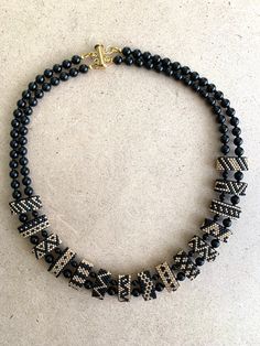 I've mixed Black and Gold Japanese seadbeads to create a versatile and fun necklace that can be used during the day or at night. Black Double Strand Beaded Necklaces For Jewelry Making, Black Heishi Beads Jewelry, Gift Heishi Beaded Necklaces With Black Beads, Handmade Black Heishi Beads, Adjustable Double Strand Black Beaded Necklace, Black Heishi Beads Necklace For Gift, Multi-strand Black Beads Necklace For Jewelry Making, Heishi Beaded Necklaces For Jewelry Making, Black Heishi Beaded Necklaces