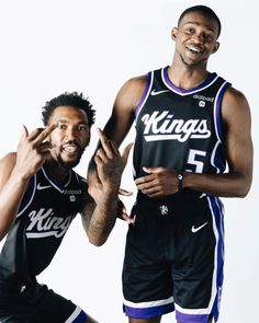 two basketball players are posing for a photo