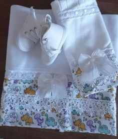 a baby's diaper and booties are laid out on a wooden table