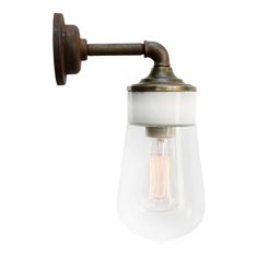 an old fashioned wall light with a glass shade on the side and a metal arm