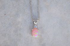 "Gorgeous pairing of a pink opal and CZ accent gemstone. The gemstones are handset into a sterling silver pendant and hung from a sterling silver chain. This pink opal has amazing flashes of color when it catches the light. The resulting necklace is stunning yet simple, a truly elegant necklace! The necklace ships in a lovely gift box ready to give as a gift or keep for yourself! Pictured with cubic zirconia accent stone color: \"White / Clear - April\" Setting Material - 925 Sterling Silver Cha Opal Necklace Silver, Necklace Opal, Elegant Necklace, Gold Jewelry Indian, Cheap Jewelry, October Birthstone, 925 Sterling Silver Chain, Elegant Necklaces, Opal Pendants