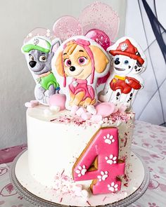 there is a birthday cake with the number four in front of it and animals on top