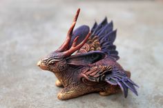 a figurine of a dragon on the ground