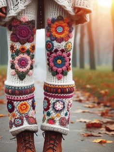 the legs and leggings of a woman wearing boots are decorated with colorful flowers