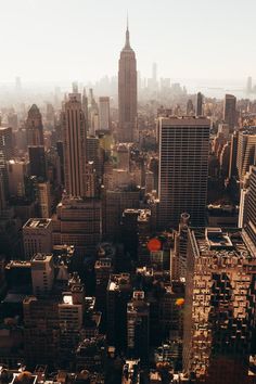 an aerial view of new york city with skyscrapers in the foreground and empire building on the far side