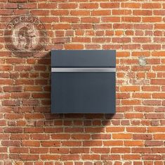 a brick wall with a metal box mounted to it's side and a seal on top