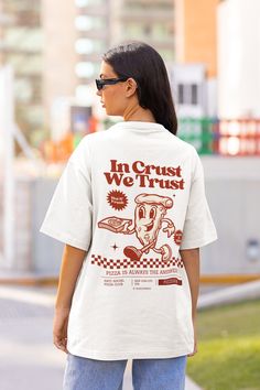 Retro Pizza Tshirt, Pizza Shirt, 90s Nostalgia Shirt with a 2 Part Design on the Front and Back, with a Quote that Reads: In Crust We Trust. Order a size or two up for an oversized look. We Offer Free UK and US Delivery. NOTE TO OUR CUSTOMERS We are a new business and very much appreciate your support! If you love your Tee as much as we hope you do, please leave us a review, thank you in advance- stay cosy and stay groovy! 💚 HOW TO ORDER 💚 1. Check our photos for sizing and colour options. 📏 Graphic Tee For Playwear, Affordable Retro T-shirt For Day Out, Cheap Fun T-shirt With Retro Print, Cheap Graphic Print Shirt For Brunch, Cheap Retro T-shirt With Custom Print, Vintage Pop Art Tshirt, Affordable 90s Inspired Summer T-shirt, Food Tshirt Design, 90s Tshirt Design