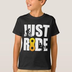 a young boy wearing a t - shirt that says just ride