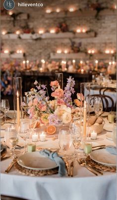 an elegant table setting with candles and flowers