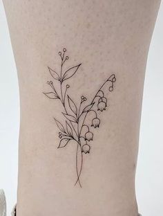 a small flower tattoo on the side of a woman's lower back ribcage