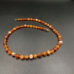 The orange color carnelian beads from my collections of ancient beads. The origin of this beads from India although the carnelian agate can be found in Pakistan Nepal and Afghanistan as well There is much or less white patina on almost every beads which shows this agate was undergrounded for many years small agate beads used as counter beads best gift for the people who collect ancient beads and best for the people who study ancient history we provide fast and free shipping to our customers by w Orange Single Strand Spiritual Necklace, Carnelian Single Strand Necklace For Healing, Orange Carnelian Hand-strung Necklace, Hand-strung Orange Carnelian Necklaces, Single Strand Carnelian Necklace In Amber, Amber Carnelian Hand-strung Necklace, Single Strand Carnelian Necklace For Healing, Amber Carnelian Single Strand Necklace, Orange Agate Round Beads Necklace