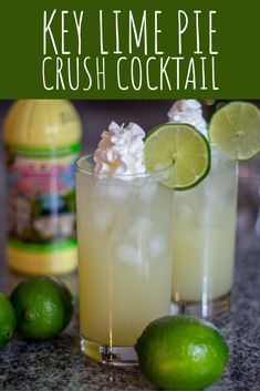 the key lime pie crush cocktail is garnished with whipped cream and limes