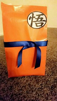 an orange bag with a blue ribbon tied around it