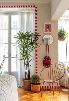 a living room filled with furniture and plants