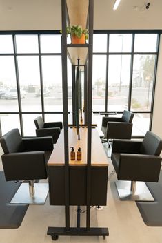 an empty room with chairs and bottles on the table