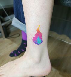 a person with a colorful tattoo on their foot