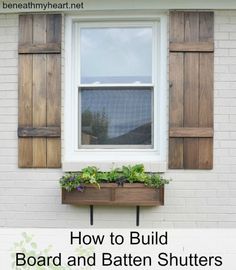 an image of a window with shutters on the outside and plants in the inside