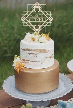 a wedding cake sitting on top of a wooden table