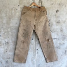 "Vintage Tan Double Knee Carhartt Pants Relaxed fit Well worn Size measured flat: 30x30 Model: 5\"10\" - Waist: 15\" (across top waistband) - Inseam: 30\" (crotch seam to bottom hem) - Rise: 12\" (crotch seam to top of waist) - Hips: 21\" (straight across below end of zipper) - Thigh: 12\" (crotch seam to outseam) - Knee: 10\" - Cuff: 9\" (lower leg opening)" Rugged Straight Leg Pre-washed Bottoms, Rugged Cotton Bottoms With Standard Cut Leg, Rugged Straight Leg Bottoms, Pre-washed, Vintage Distressed Cotton Pants, Vintage Relaxed Fit Distressed Pants, Vintage Distressed Relaxed Fit Pants, Double Knee Carhartt, Pantalon Carhartt, Carhartt Pants