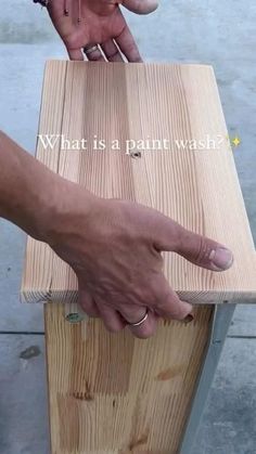 two hands on top of a piece of wood