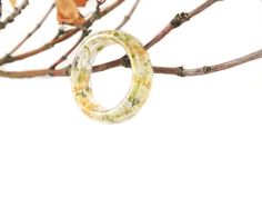 "Wear this ring and literally have summer in the palm of your hand... Eco resin ring with Baby's breath and gold flakes. They are about 7mm wide, 1/8\" (4mm) thick, so they look wonderful on their own, or as chunky stacking rings. Each one is handmade from start to finish, and come in a variety of sizes. Made with high grade eco-friendly jewelers resin. Glossy surface. For help figuring out your ring size, check out http://en.wikipedia.org/wiki/Ring_size Each finished jewelry listing will arrive Summer Flower Shaped Jewelry Gift, Spring Yellow Round Jewelry, White Jewelry For Spring Gifts, Yellow Rings For Summer Gift, Handmade Resin Rings As A Gift, Resin Jewelry For Summer Gifts, Unique Resin Rings For Gifts, Handmade Clear Rings For Gifts, Summer Gift Jewelry Made Of Resin