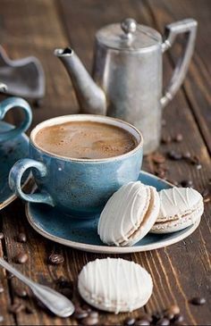 a cup of coffee and some cookies on a table