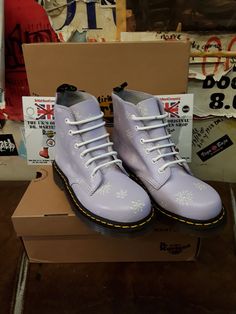 These 6 hole boots are definitely a rare colour combination.  They are a Dr Martens boot finished in a Lilac leather with a snowflake background.  They are very cute and in short supply. They have trademark cushioned sole unit and yellow stitching.  We have various sizes, please check the listing. Winter Snow Boots With Lace-up Design, Winter Boots With Laces And Round Toe, Casual High-top Snow Boots, Winter Streetwear Boots With Laces, Winter Lace-up Boots For Streetwear, White Winter Boots With Rubber Sole, Purple Waterproof Boots With Round Toe, Purple Waterproof Round Toe Boots, White Lace-up Winter Boots