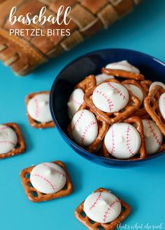 baseball pretzel bites in a bowl on a blue table with pretzels