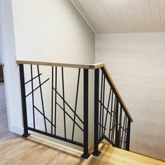 an empty room with white walls and black railings on the bottom half of it