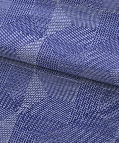 a blue and white checkered fabric with an interesting pattern on it's surface