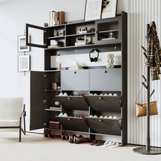 an open bookcase with shoes on it in a living room next to a chair