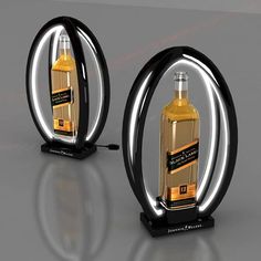 two bottles of liquor are shown in the shape of an oval, with lights on each side