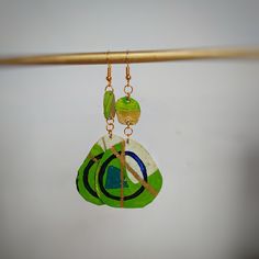 Long green graphic earrings.A beautiful pair of recycled metal earrings, hand painted with acrylics and finished with gold gilding cream Green Earrings With Artistic Design For Gift, Artsy Green Earrings For Gift, Artistic Green Jewelry With Matching Earrings, Artsy Green Earrings With Ear Wire, Unique Green Jewelry With Artistic Design, Artistic Green Earrings For Gift, Artsy Hand Painted Green Jewelry, Artsy Green Dangle Jewelry, Artistic Green Jewelry Set With Matching Earrings