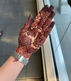 a woman's hand with henna on it