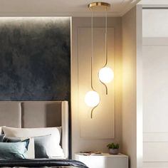 a bedroom with a large bed and two lights hanging from the headboard on the wall