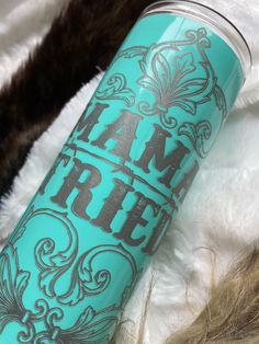 thermos cup is sitting on top of some furry fur and it says am free