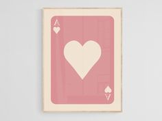 a pink and white ace playing card with two hearts on it's back side