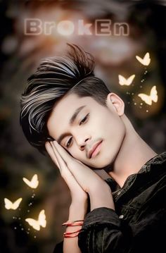 a young man with black hair and butterflies in the background