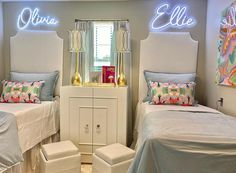 two twin beds with lights above them in a bedroom