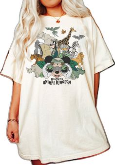 a woman wearing a white shirt with animals on it