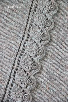 a close up of a sweater with buttons on it