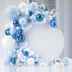 blue and white balloons are arranged in the shape of a wreath